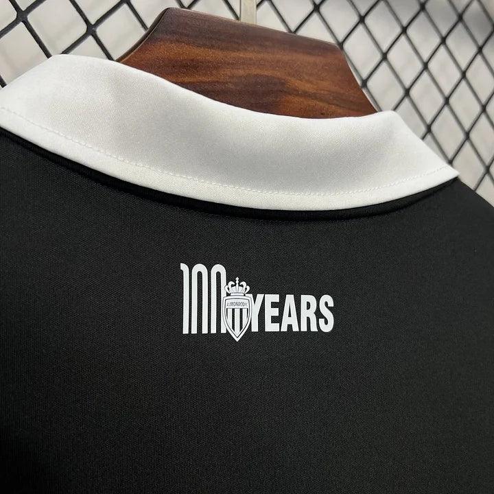 Maillot de football noir AS Monaco 2024-2025, fabriqué par Le 12 -ème Maillot, avec logo et détails du club visibles.