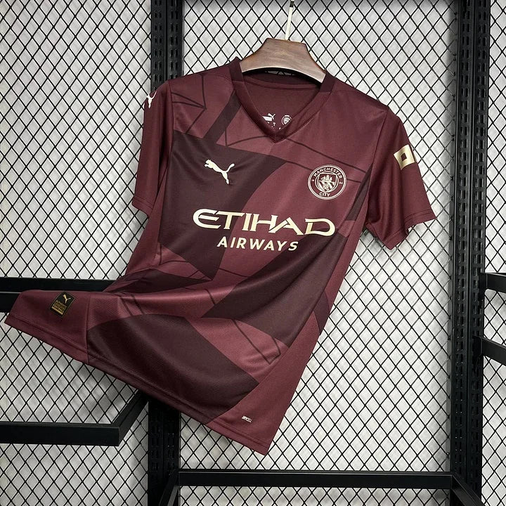 Maillot Manchester City 2024/25 Le 12 -ème Maillot, maillot de football avec logo et détails de l'équipe sur le devant.