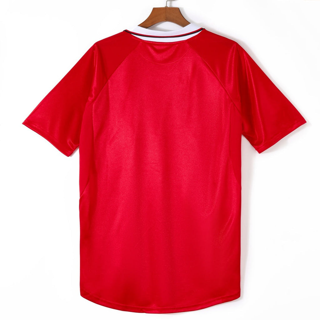 Maillot domicile rétro Manchester United 1999-2000, marque Le 12, avec logo et détails du maillot de football.