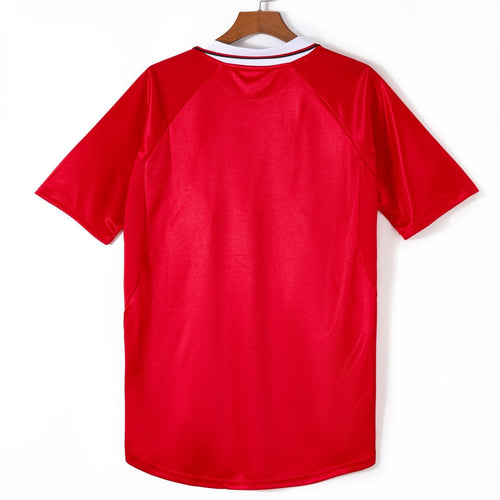 Maillot domicile rétro Manchester United 1999-2000, marque Le 12, avec logo et détails du maillot de football.