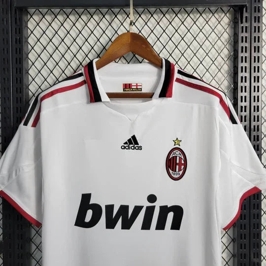 Maillot rétro Milan AC 2009-2010 de la marque Le 12-ème, vue de face avec logo et détails du design vintage.