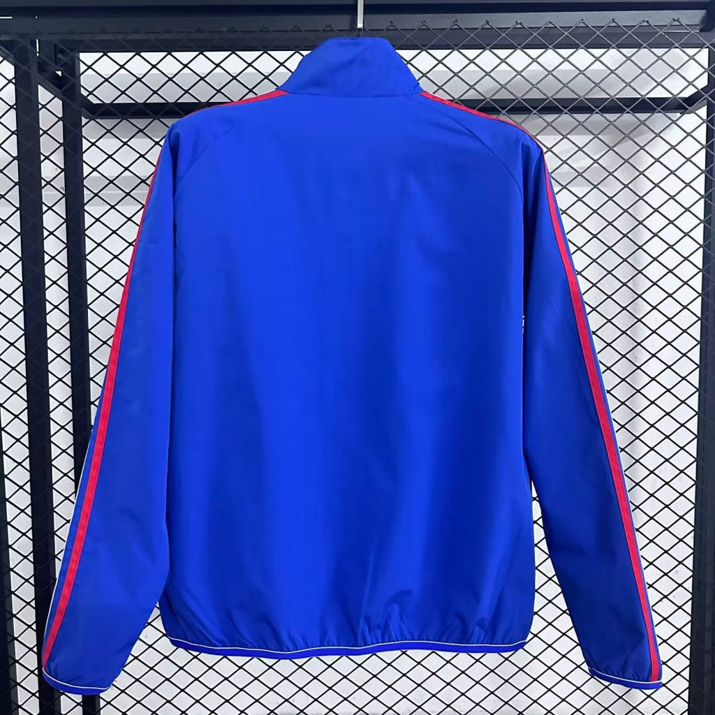 Veste coupe-vent réversible Le 12 -ème Maillot, modèle Italie, en tissu léger avec design coloré et fermeture éclair frontale.