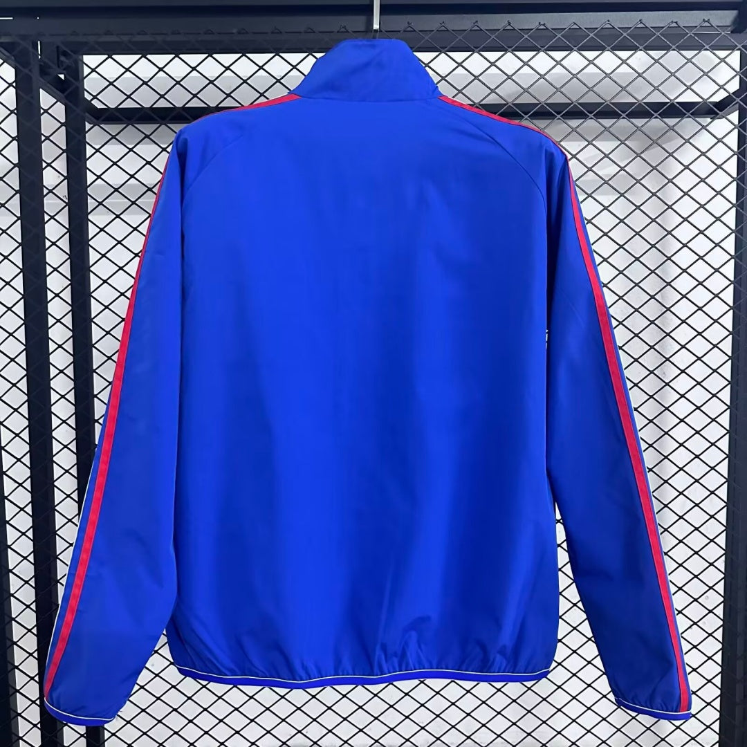 Veste coupe-vent réversible Le 12 -ème Maillot, modèle Italie, en tissu léger avec design coloré et fermeture éclair frontale.