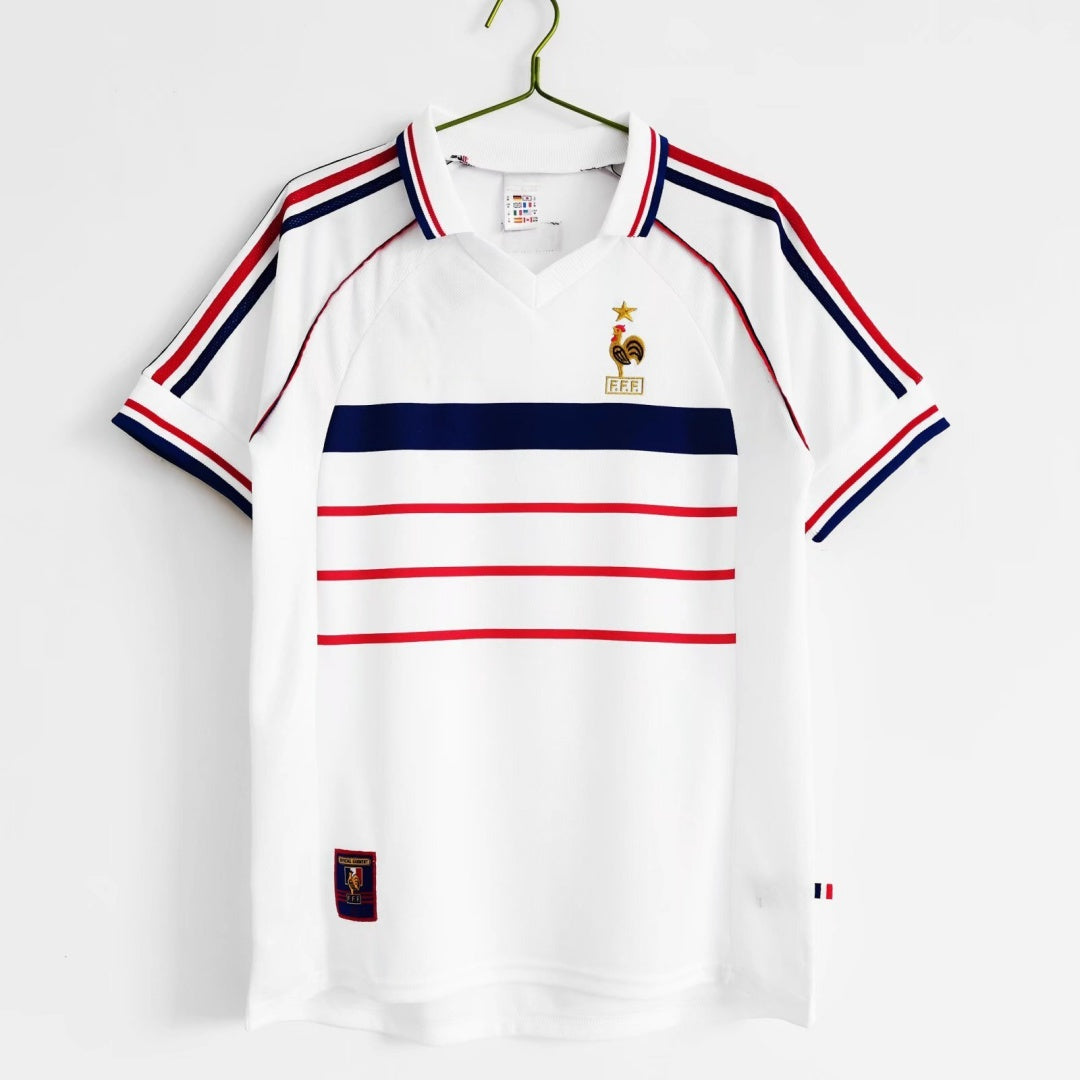Maillot rétro de l'équipe de France 1998, marque Le 12 -ème Maillot, vue du maillot avec logo et détails colorés.