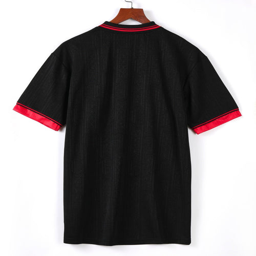 Maillot rétro third de l'AC Milan 1997-1998, marque Le 12ème, vue de face avec logo et détails du design orange et noir.