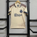Maillot Ajax troisième 2025/26 de la marque Le 12, vue de face avec détails du design orange et bleu.