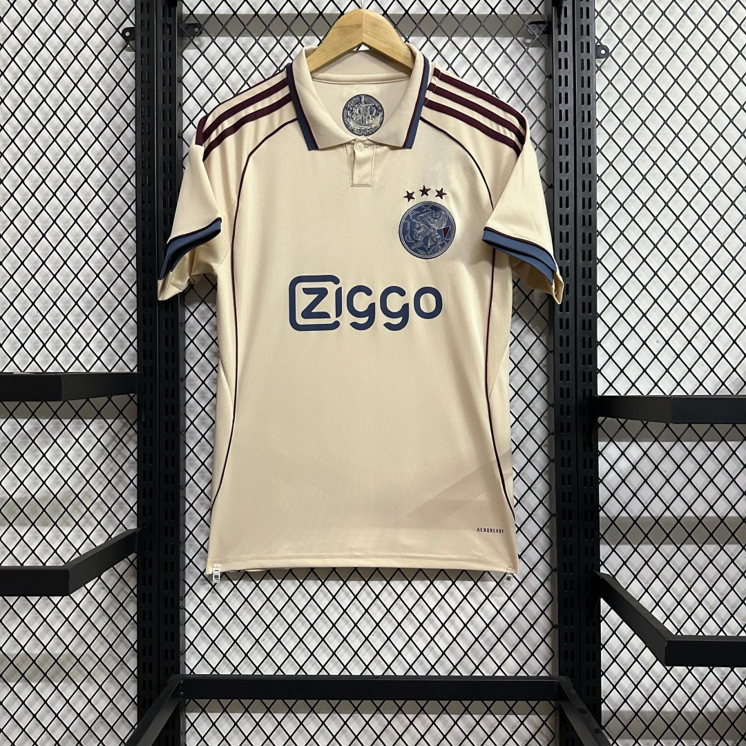 Maillot Ajax troisième 2025/26 de la marque Le 12, vue de face avec détails du design orange et bleu.
