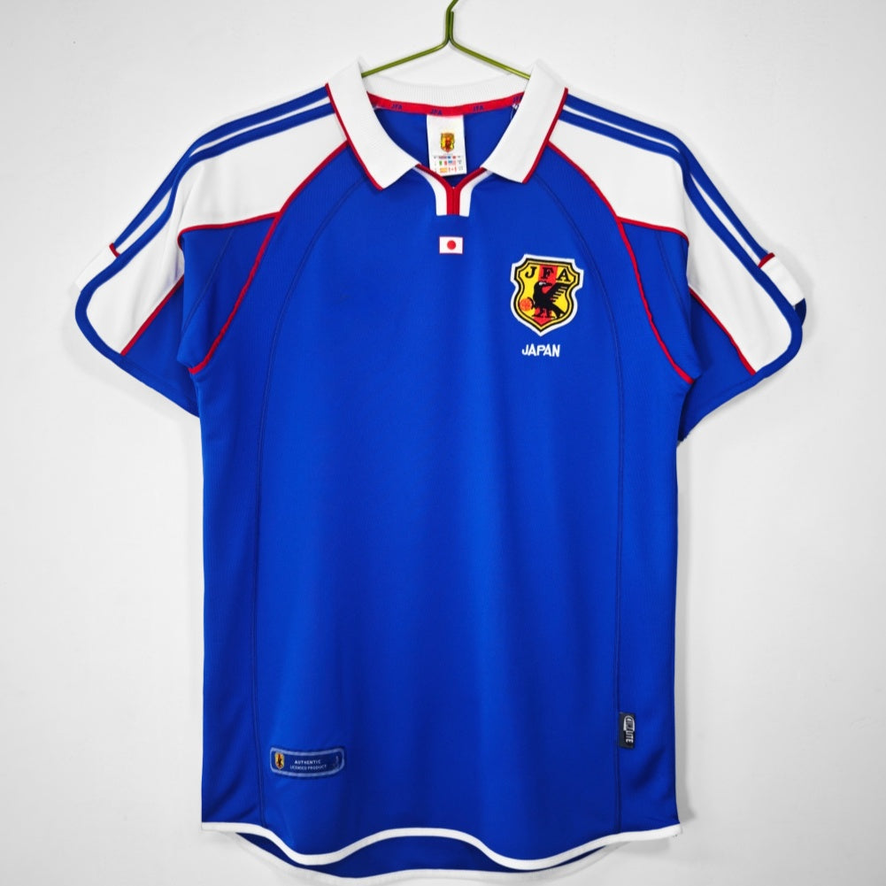 Maillot domicile rétro du Japon 2000, marque Le 12-ème Maillot, avec design classique et logo national visible.