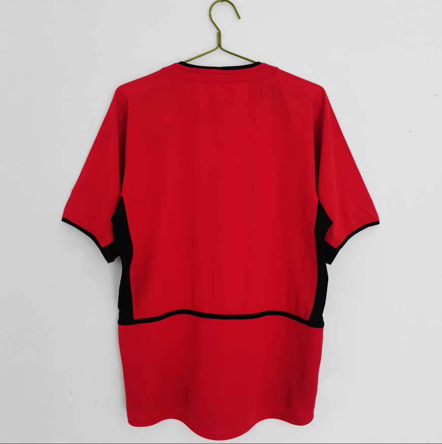Maillot domicile rétro Manchester United 2002-2004, marque Le 12 -ème Maillot, avec logo et détails classiques.
