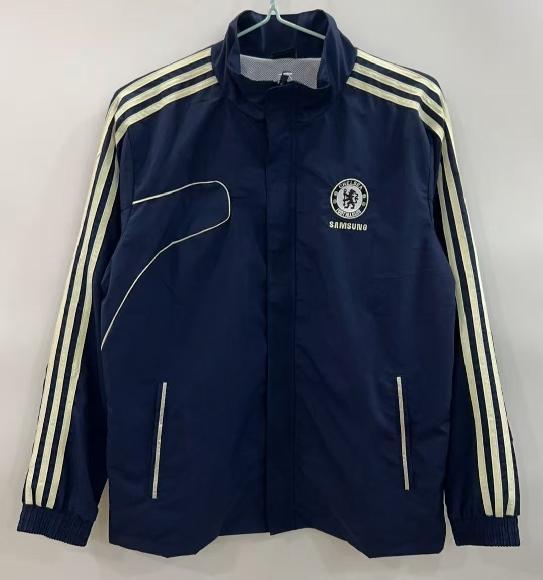 Veste coupe-vent réversible Chelsea de Le 12 -ème Maillot, doublée et légère, avec capuche et fermeture éclair.