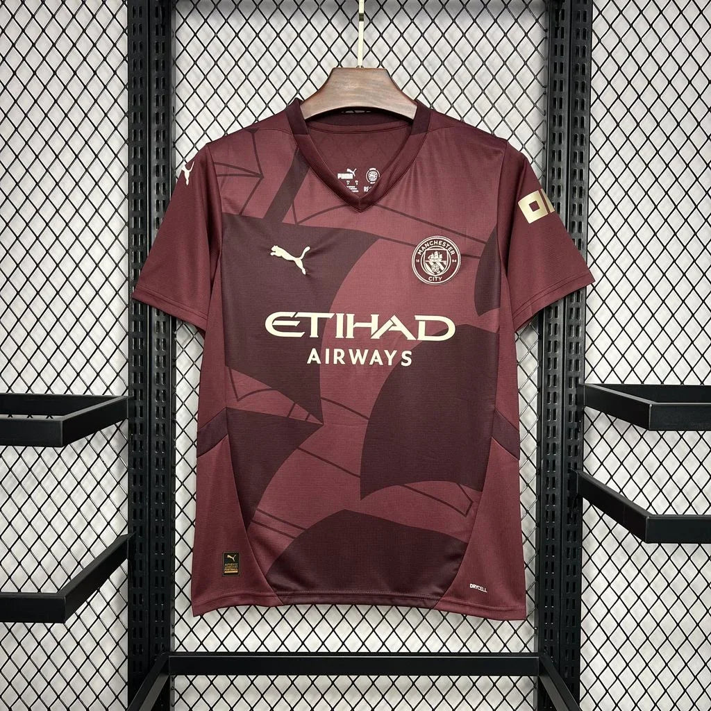 Maillot Manchester City 2024/25 Le 12 -ème Maillot, maillot de football bleu avec logo du club et détails de design.