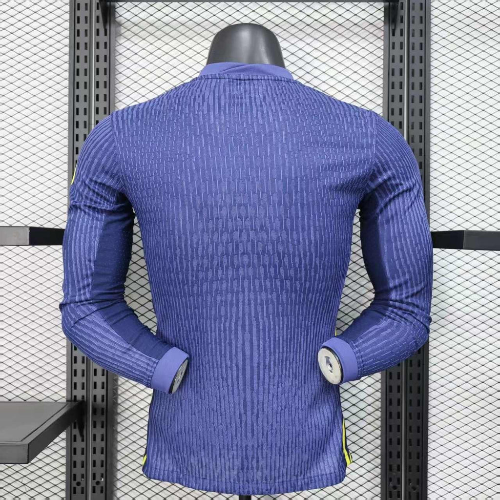 Maillot à manches longues de l'Atlético Madrid 2025-26, marque Le 12 -ème Maillot, tissu bleu avec logo officiel.