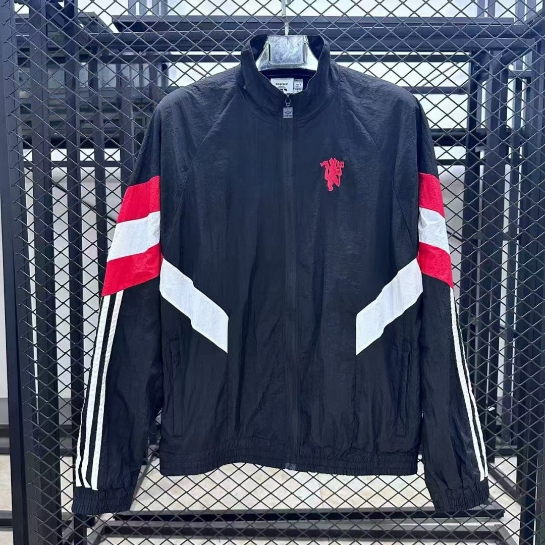 Veste coupe-vent réversible Manchester United Le 12 -ème Maillot, design coloré avec logo de l'équipe visible.