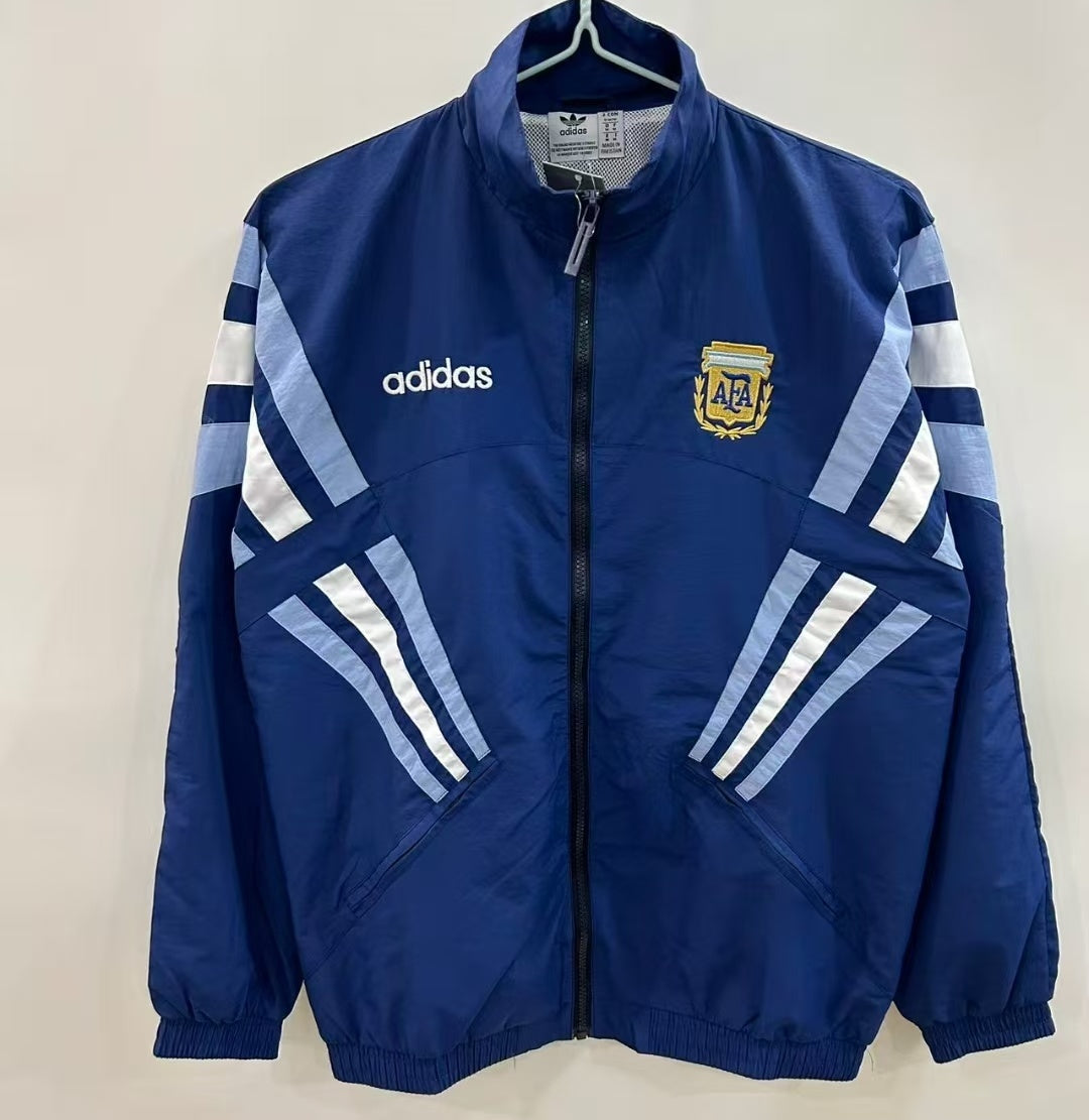 Veste coupe-vent réversible Le 12 -ème Maillot, Argentine, en tissu léger avec logo visible, portée en plein air.
