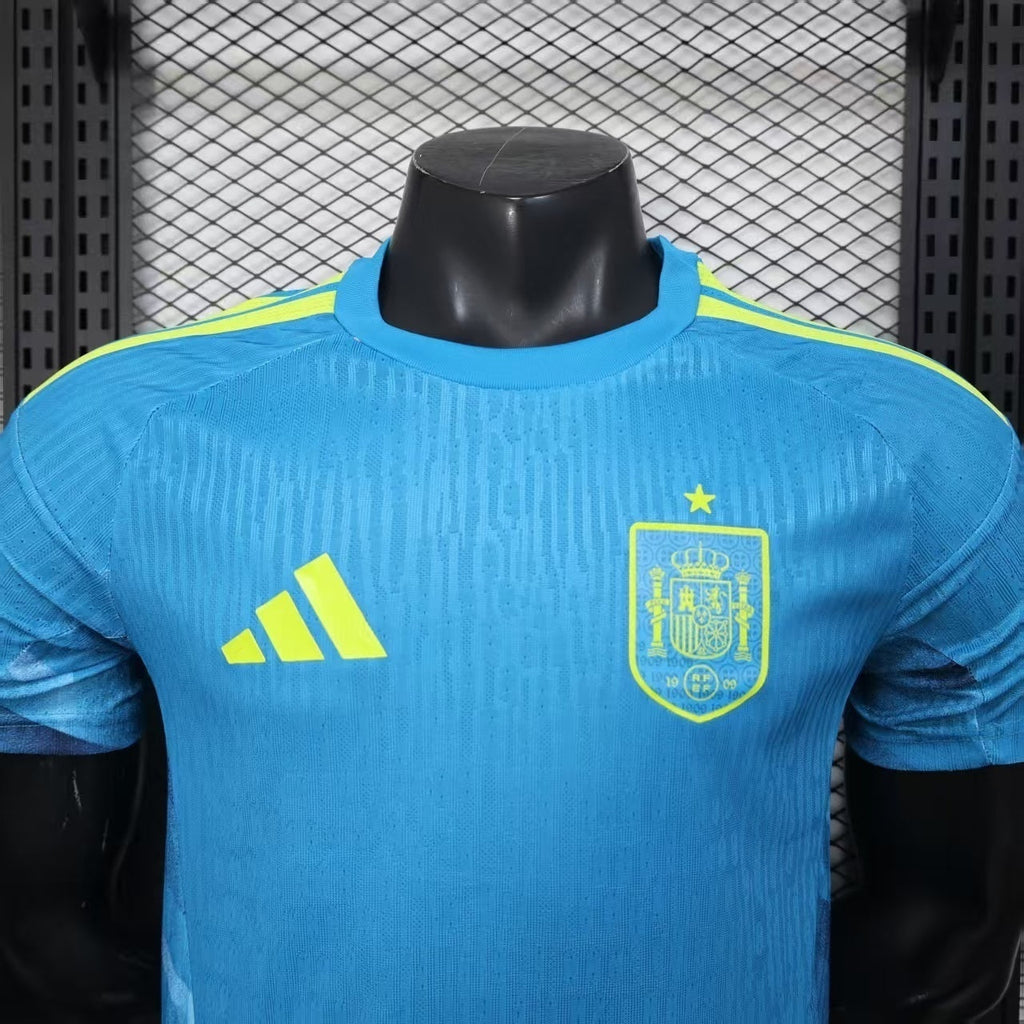 Maillot d'entraînement Espagne Coupe du Monde 2026, marque Le 12, devant avec logo et détails bleus et rouges.