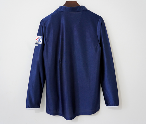 Maillot domicile rétro PSG 2001-2002 à manches longues, marque Le 12 -ème Maillot, en bleu avec logo du club.