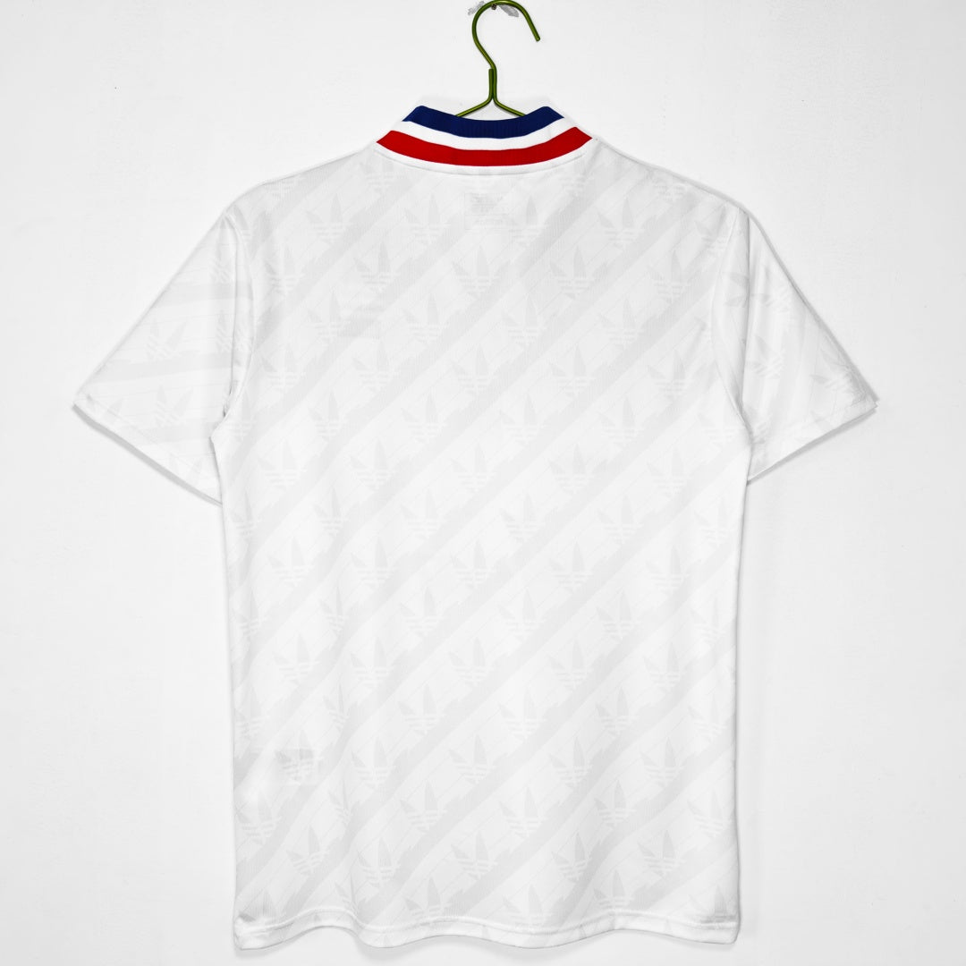 Maillot domicile rétro de Lyon 1995-1996, marque Le 12 -ème Maillot, vue de face, bleu avec détails blancs, style vintage.