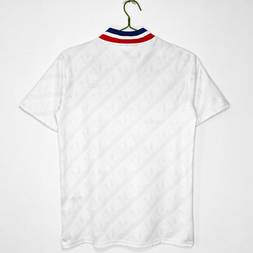 Maillot domicile rétro de Lyon 1995-1996, marque Le 12 -ème Maillot, vue de face, bleu avec détails blancs, style vintage.