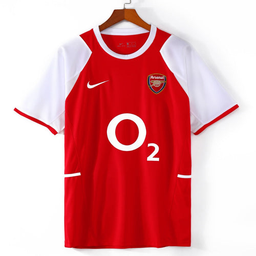 Maillot domicile rétro de l'Arsenal 2002-2004, signé Le 12 -ème Maillot, avec logo et couleurs traditionnelles du club.