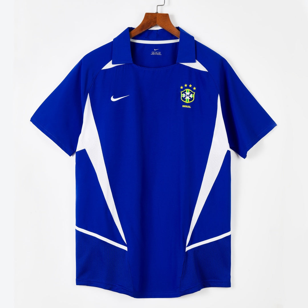 Maillot extérieur rétro 2002 du Brésil, marque Le 12 -ème Maillot, visible avec détails du design et des couleurs officielles.