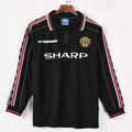 Maillot extérieur Manchester United rétro 1998-1999 à manches longues, marque Le 12 -ème Maillot, tissu rouge et blanc.