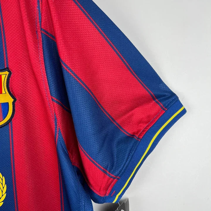 Maillot rétro FC Barcelone 2009/10 de Le 12, maillot de football avec logo du club et design classique, vue de face.