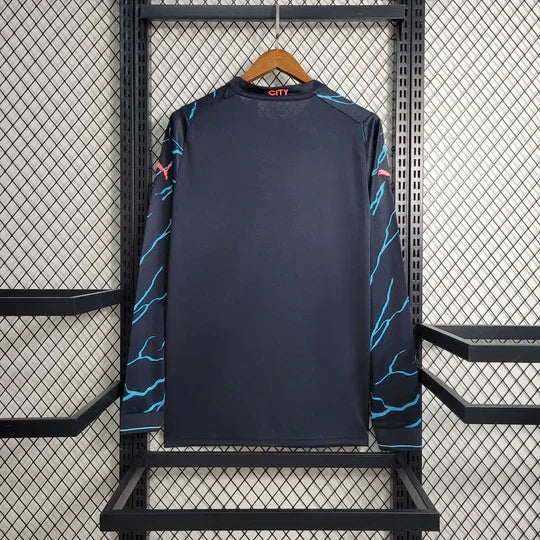 Maillot Manchester City extérieur 2023 2024 à manches longues, marque Le 12 -ème Maillot, vue de face avec logo et détails bleus