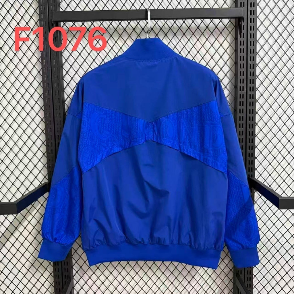 Veste coupe-vent réversible Chelsea bleue de Le 12 -ème Maillot, vue de face, avec capuche et fermeture éclair.