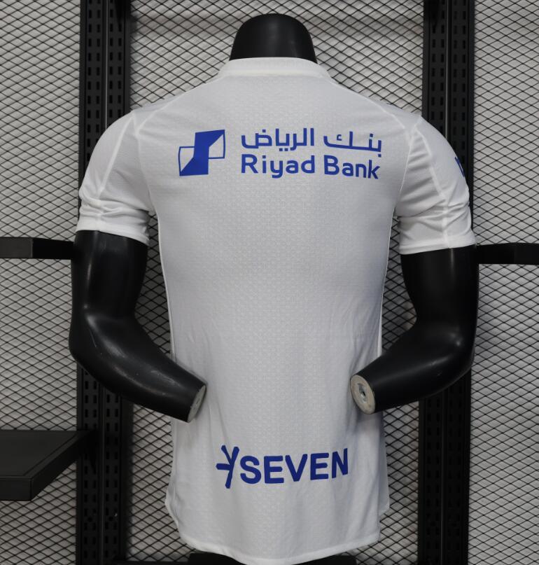 Maillot extérieur du club Al-Hilal 2025-26, marque Le 12, en tissu bleu avec logo et détails du maillot.