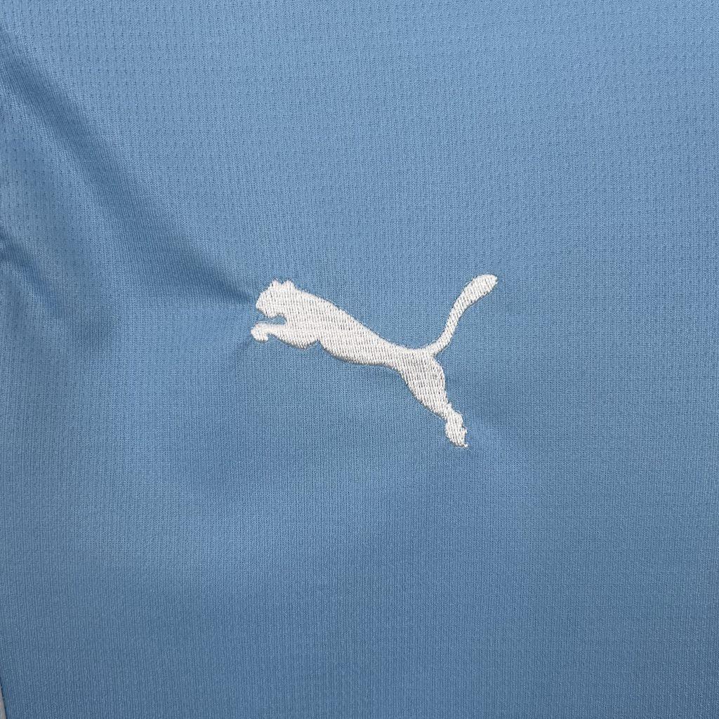 Maillot Manchester City 2025-26 Le 12 -ème Maillot, devant, en bleu avec logo et détails sportifs visibles.