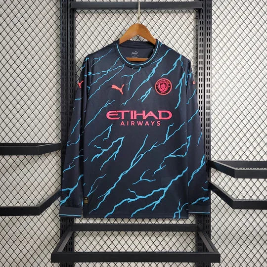 Maillot extérieur Manchester City 2023-2024 à manches longues, marque Le 12 -ème Maillot, vue frontale avec logo de l'équipe.