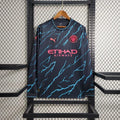 Maillot extérieur Manchester City 2023-2024 à manches longues, marque Le 12 -ème Maillot, vue frontale avec logo de l'équipe.