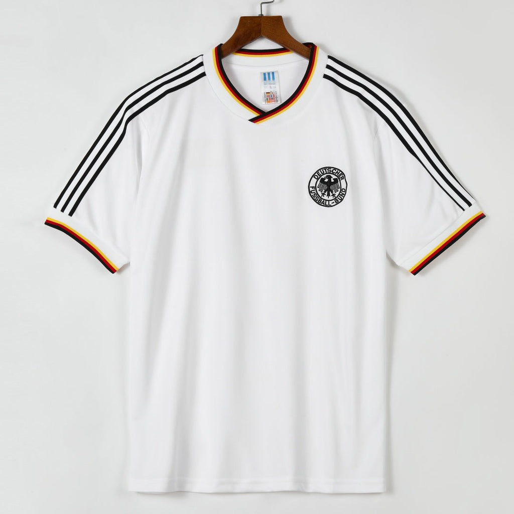 Maillot domicile rétro de l'Allemagne 1986, marque Le 12 -ème Maillot, vue de face avec logo et design traditionnel.