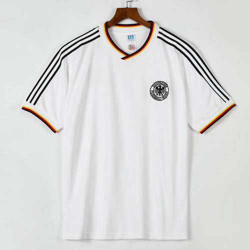 Maillot domicile rétro de l'Allemagne 1986, marque Le 12 -ème Maillot, vue de face avec logo et design traditionnel.