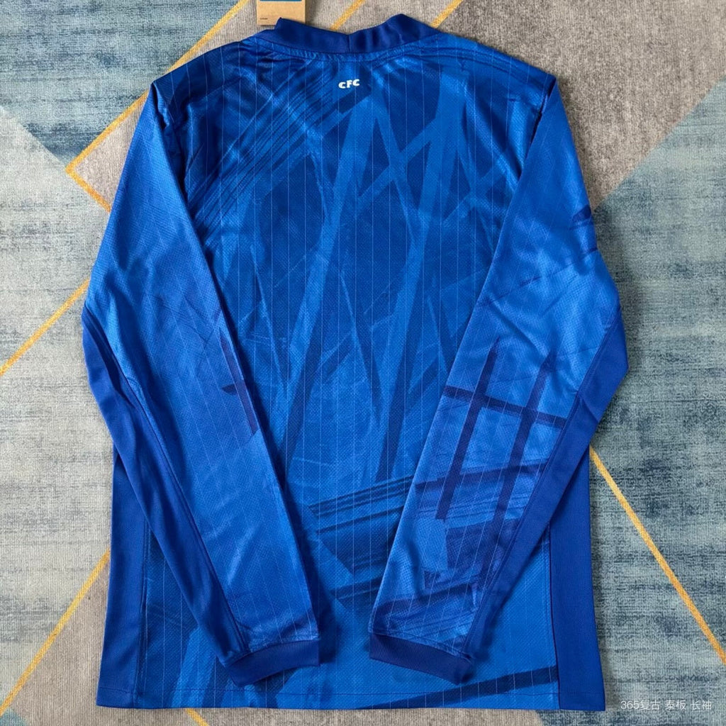 Maillot domicile Chelsea 25/26 à manches longues, marque Le 12 -ème Maillot, bleu avec logo du club.