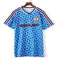 Maillot extérieur rétro Manchester United 1990-1992, marque Le 12-ème Maillot, vue de face avec logo et détails de l'équipe.