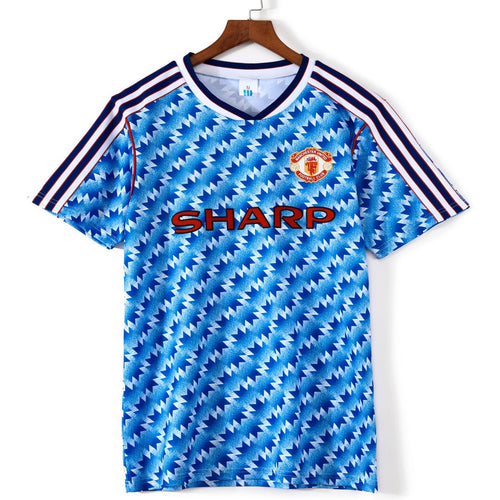 Maillot extérieur rétro Manchester United 1990-1992, marque Le 12-ème Maillot, vue de face avec logo et détails de l'équipe.