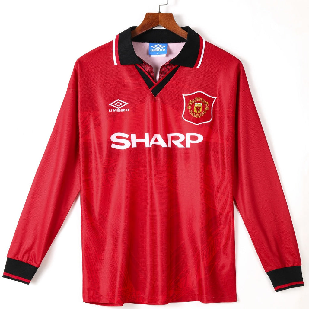Maillot domicile rétro Manchester United 1994-1996 à manches longues, marque Le 12 -ème Maillot, logo et design vintage visible.