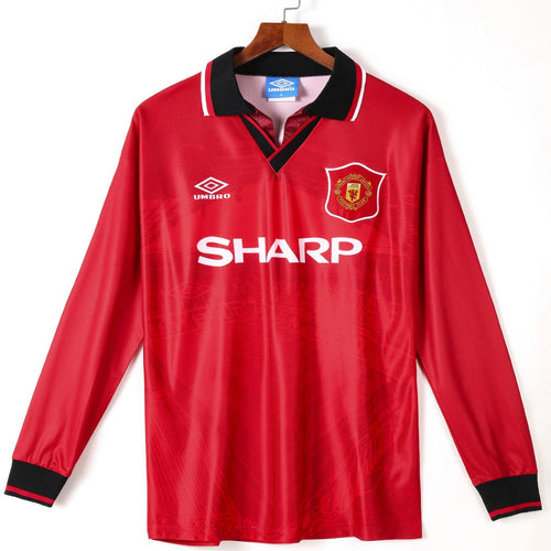 Maillot domicile rétro Manchester United 1994-1996 à manches longues, marque Le 12 -ème Maillot, logo et design vintage visible.