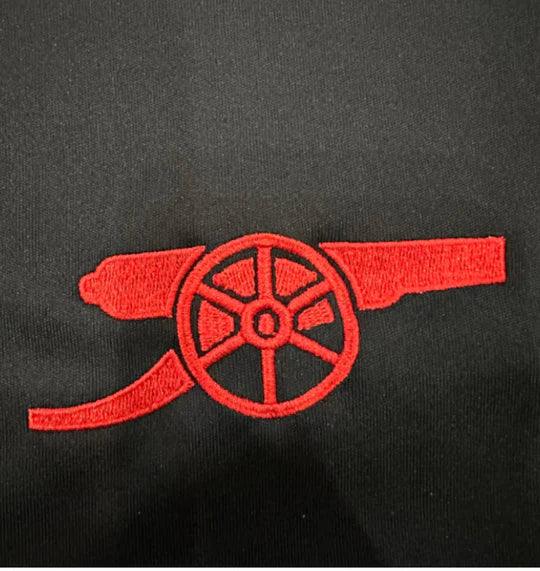 Maillot extérieur Arsenal 2024/25 Le 12 -ème Maillot, vue frontale avec logo et motif bleu et rouge.