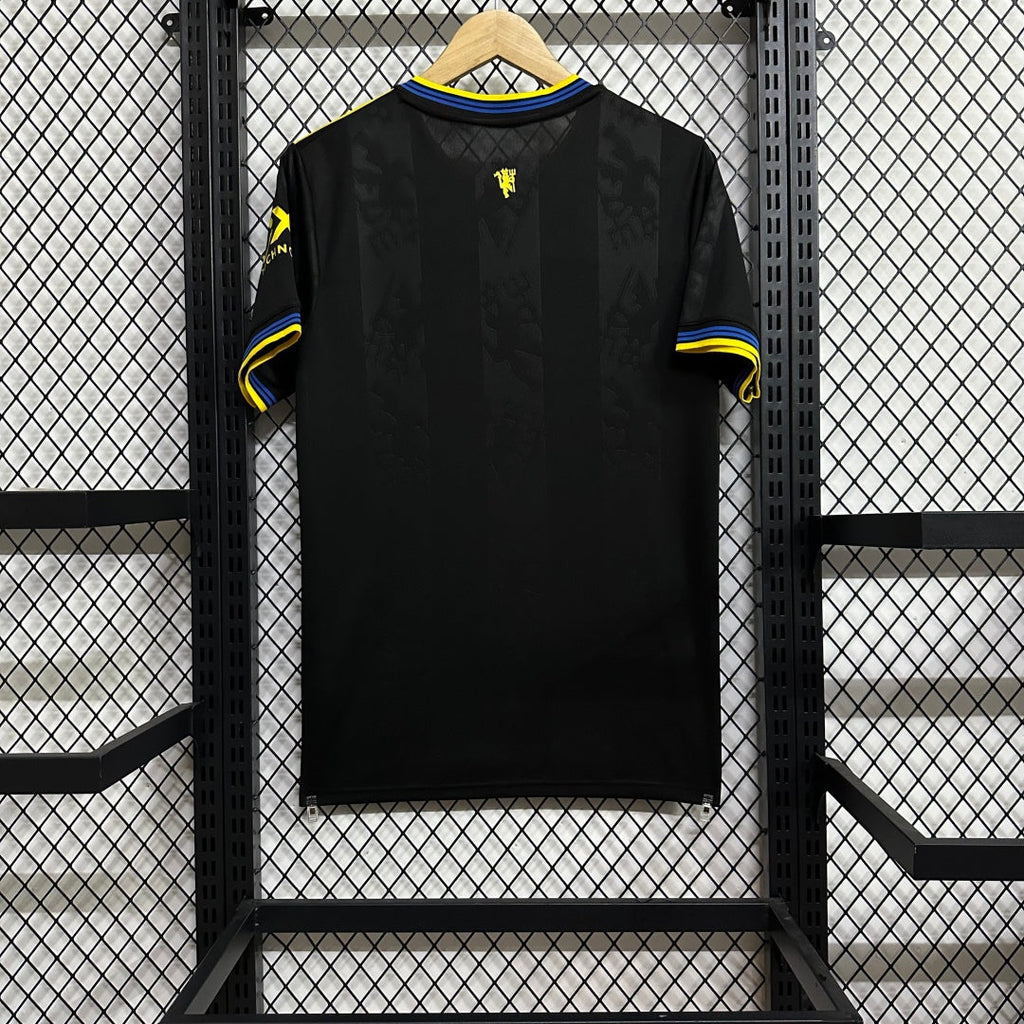 Maillot third Manchester United 2025-2026 de la marque Le 12-ème Maillot, vue de face, détail du design et logo rouge.
