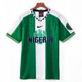 Maillot domicile rétro du Nigeria 1996, marque Le 12-ème Maillot, maillot de football jaune avec détails verts.