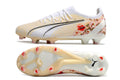 Crampons Ultra Ultimate FG Le 12 -ème Maillot, fixation métallique pour chaussures de sport, vue en gros plan.