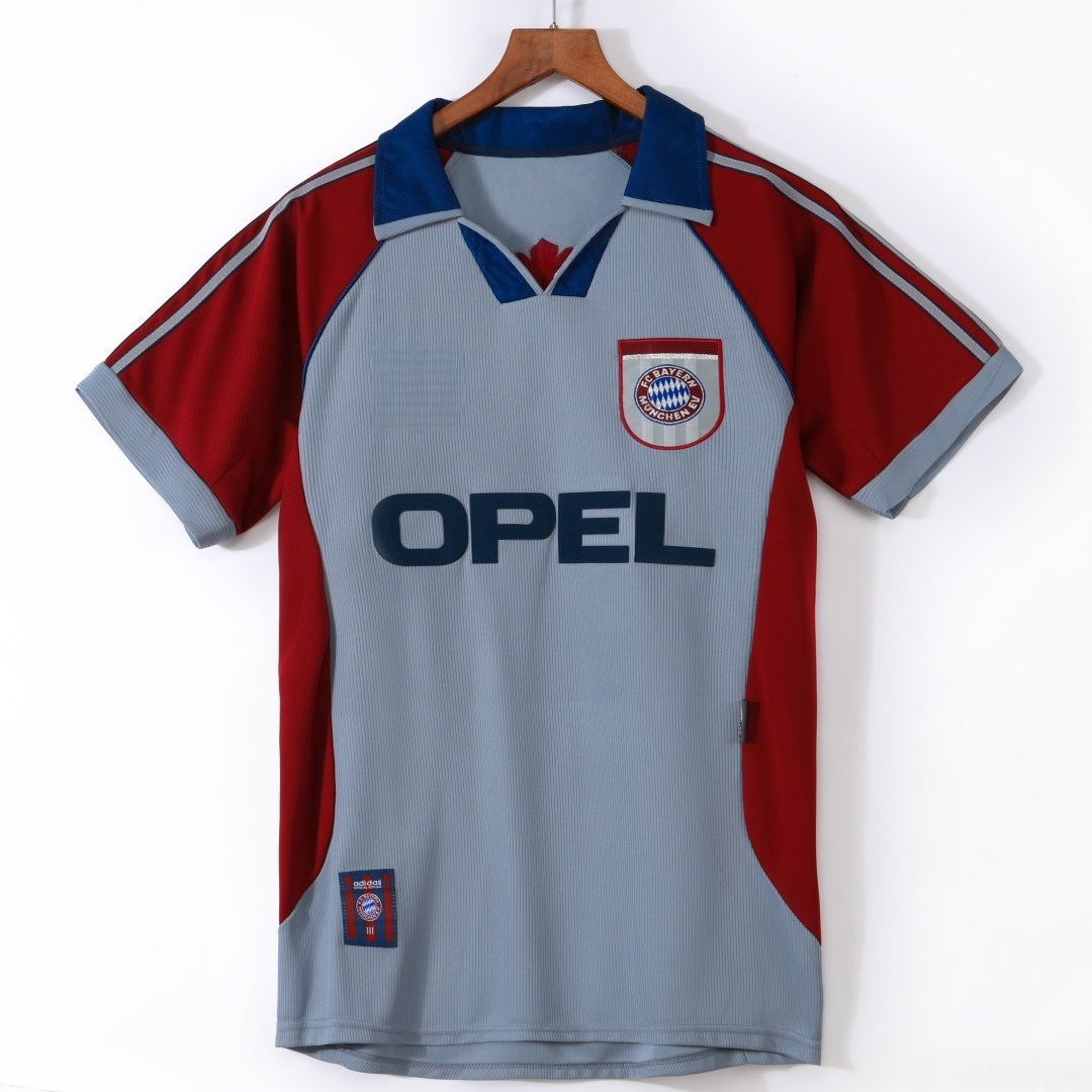Maillot Bayern Munich 1998-1999 troisième rétro de la marque Le 12 -ème Maillot, vue de face avec logo et motifs colorés.