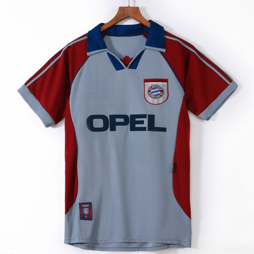 Maillot Bayern Munich 1998-1999 troisième rétro de la marque Le 12 -ème Maillot, vue de face avec logo et motifs colorés.
