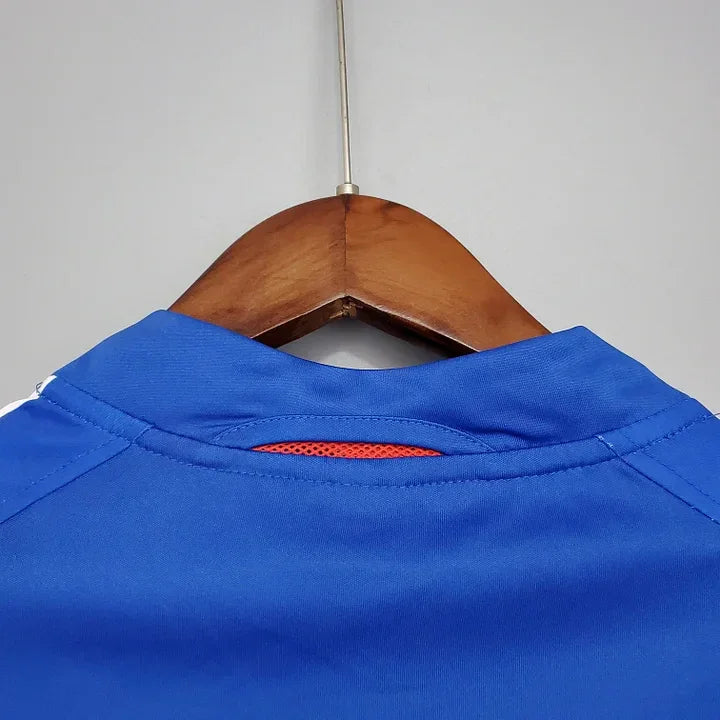 Maillot de l'équipe de France 2004 Le 12, maillot de football bleu avec logo et détails rouges et blancs.