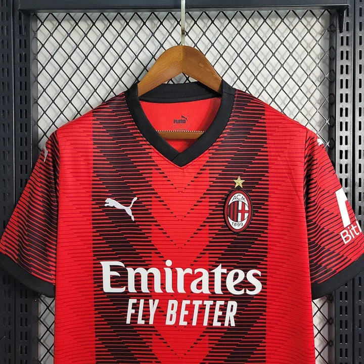 Maillot domicile AC Milan saison 2023-2024, marque Le 12 -ème Maillot, vue de face avec logo et couleurs rouges et noires.