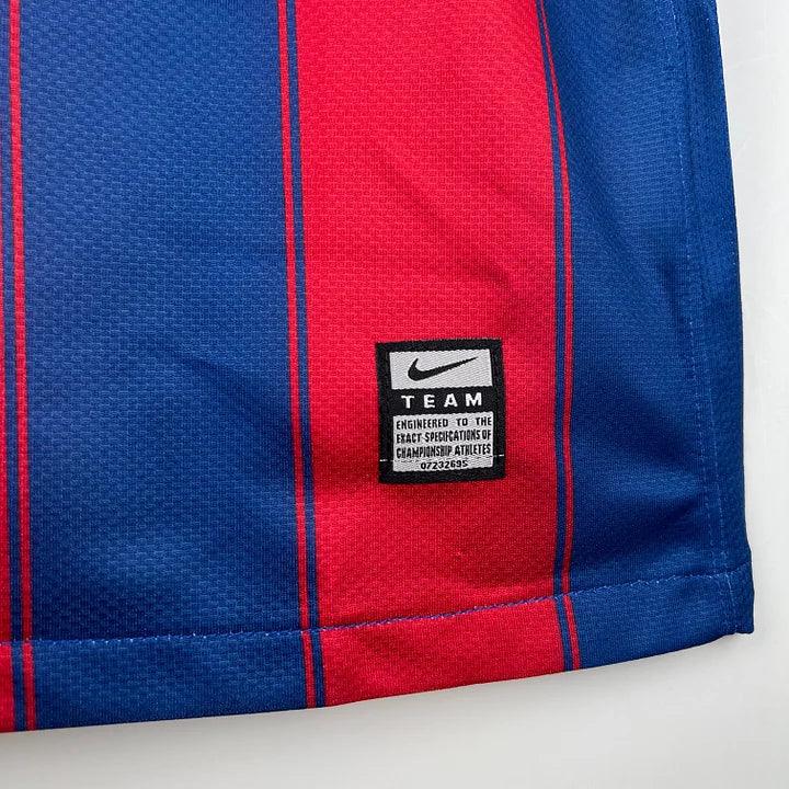 Maillot rétro FC Barcelone 2009/10 Le 12, maillot de football avec logo et design classique, vue de face.