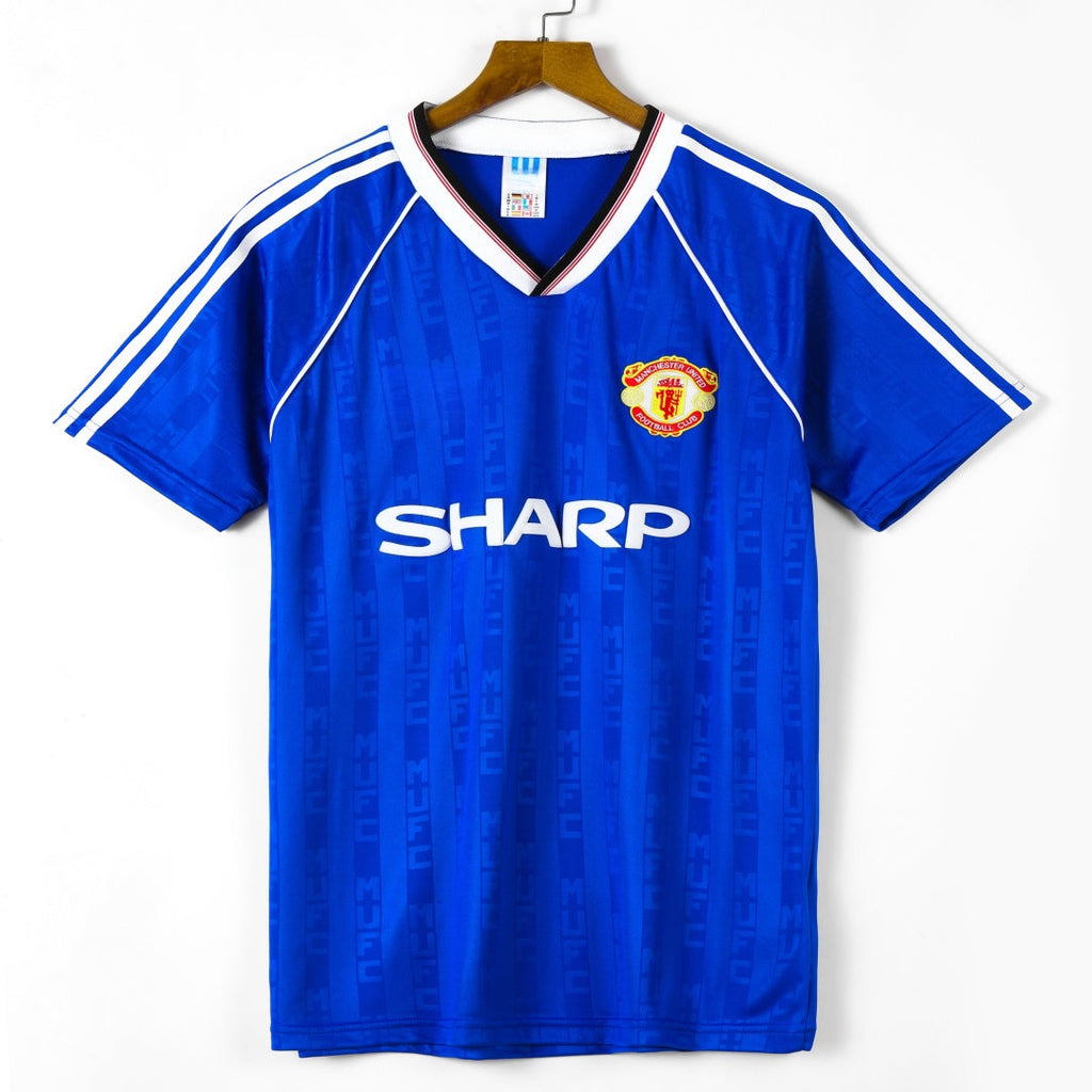 Maillot Manchester United troisième rétro 1988-1990 par Le 12 -ème Maillot, vue de face avec logo et détails du maillot.