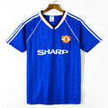 Maillot Manchester United troisième rétro 1988-1990 par Le 12 -ème Maillot, vue de face avec logo et détails du maillot.